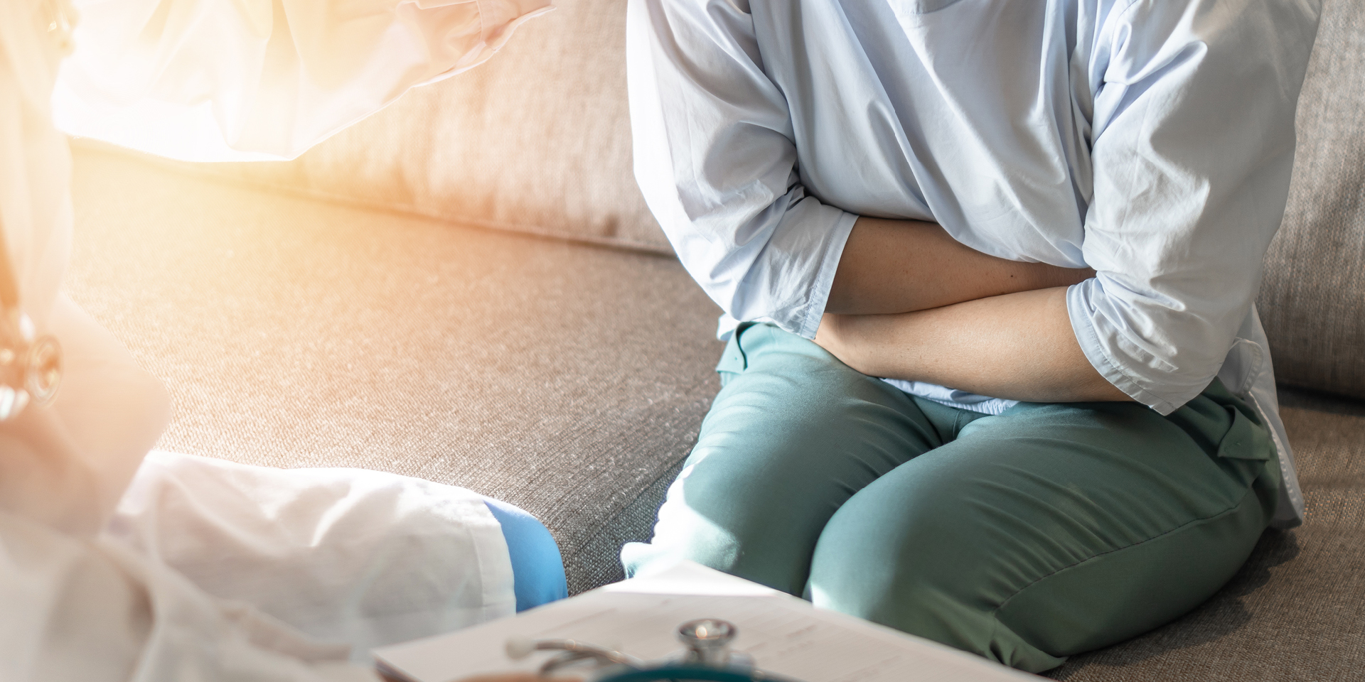 woman clutching stomach