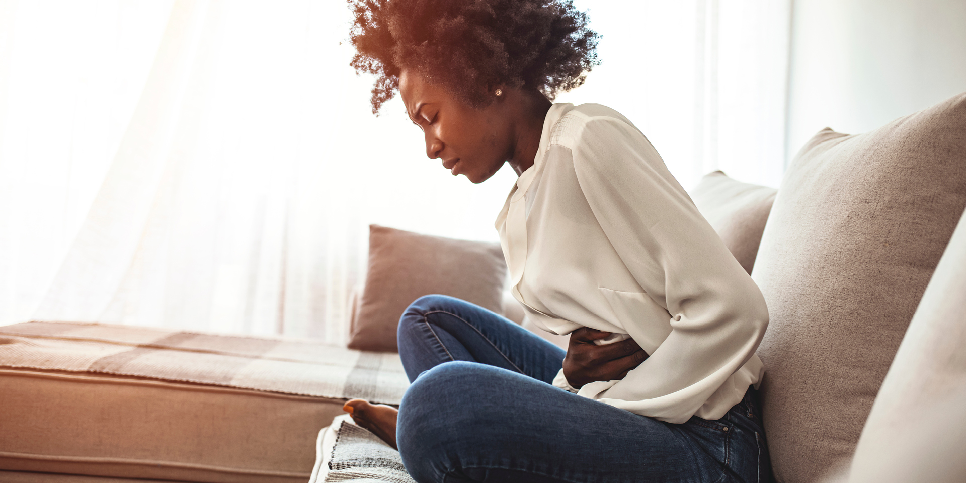 woman clutching stomach