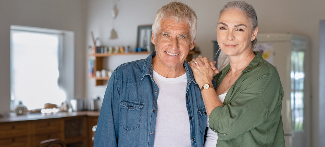 Couple smiling at the camera, senior couple at home | Doylestown Health